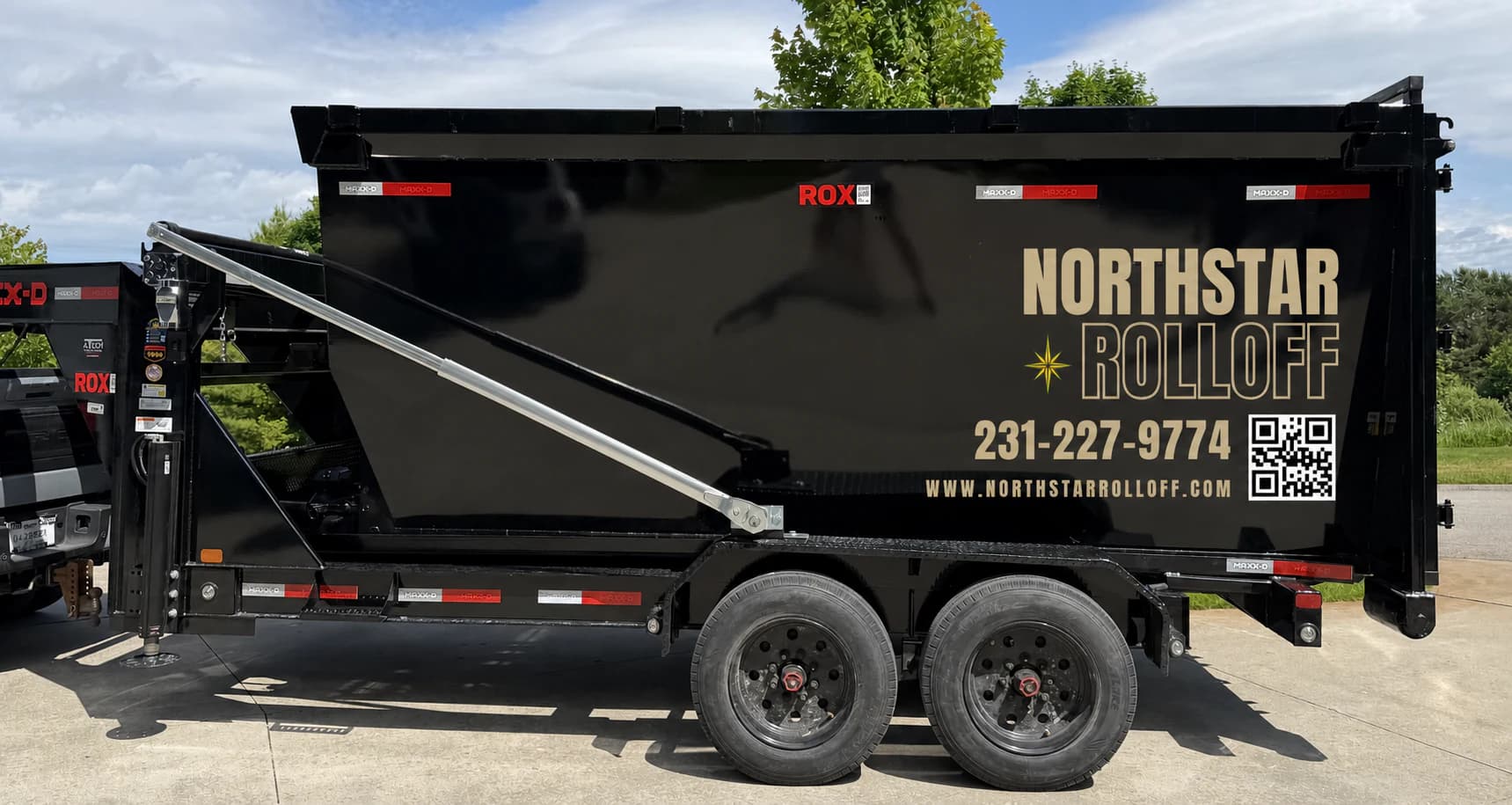 Northstar black roll-off dumpster with its approved side decal